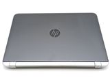 the back view of a laptop with a silver hp logo on the screen