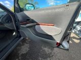 the door of a car with a wooden stick sticking out of it ' s side