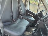 two seats in the back of a van with a steering wheel