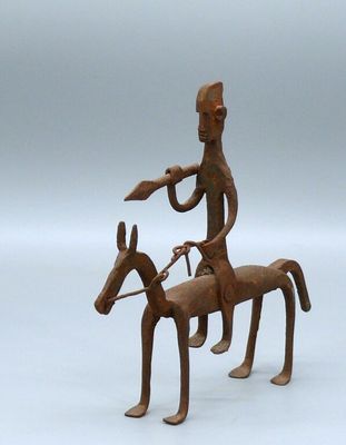 statue of a man riding a horse with a bird on its back