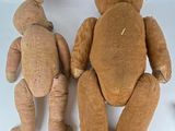 two teddy bears sitting next to each other on a white surface