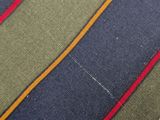 a close up of a striped tie on a white table