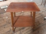 une petite table en bois à roulettes posée sur un parquet