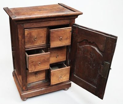a small wooden cabinet with drawers inside of it