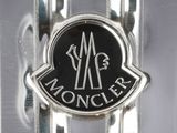 an image of a close up of a metal object with a monogram on it