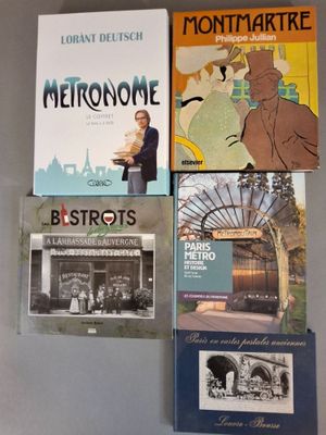 four books are stacked on top of each other on a table