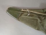 a green bag with a zipper on it sitting on a table