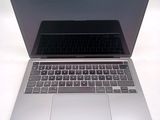 a silver laptop with a black keyboard on a white table