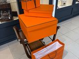 several orange boxes are stacked on top of each other on a cart