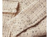 a close up of a sweater with a button on it