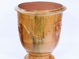a wooden vase that is sitting on a white surface