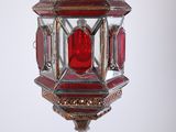 an image of a red glass lantern hanging from a ceiling