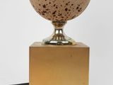 an image of a lamp with a speckled egg on it