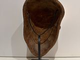 sculpture of a wooden bowl on a metal stand on a white surface
