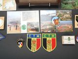 a lot of patches and pictures on the table