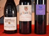 three bottles of wine sitting on a table next to each other