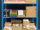 a blue shelf with many boxes and boxes on it