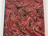 red, green, and blue marbled paper on a white surface