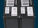 two boxes of toothpaste sitting on a table