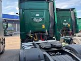 two trucks that are parked next to each other