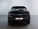 the rear end of a black car in a white room