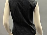a mannequin wearing a black shirt and beige pants