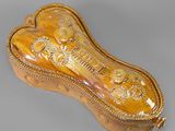 an ornately decorated wooden box with a gold decoration on it