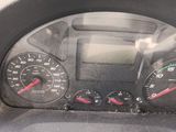 a close up of a car dashboard with a speedometer and gauges