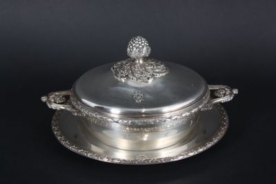 an antique silver plate with a lid and a flower decoration