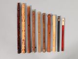 many different types of flutes lined up on a white surface