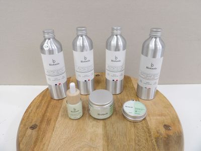bottles of skin care products on a wooden tray on a table