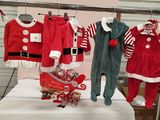 a display of baby clothes for sale at a christmas market