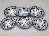 a set of six blue and white plates with floral designs