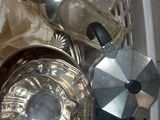 a lot of silver items in a basket on the floor