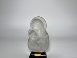 an image of a glass buddha figurine on a black base