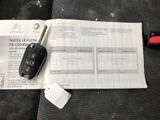 a car key and a remote control on the seat of a car