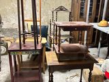 several pieces of furniture are sitting in a room with a lot of junk