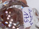 a person holding a crystal ball with a sticker on it