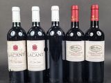 six bottles of wine are lined up in a row on a table