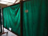 a room with a green curtain on the wall