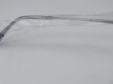 a toothbrush in a plastic bag on a white surface