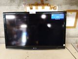 a flat screen tv sitting on top of a table