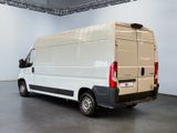 an image of a white van parked in a room