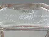 a glass vase with a silver lid on a table