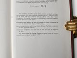 an open book with a gold ring on it