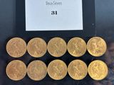 a close up of a bunch of gold coins sitting on top of a table