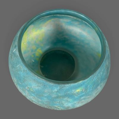 a blue vase that is sitting on a table