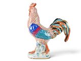 a figurine of a rooster on a white background