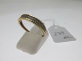 gros plan d'une bague sur une surface blanche avec une étiquette de prix