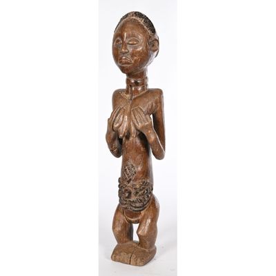 a wooden statue of a woman holding a cat in her hands